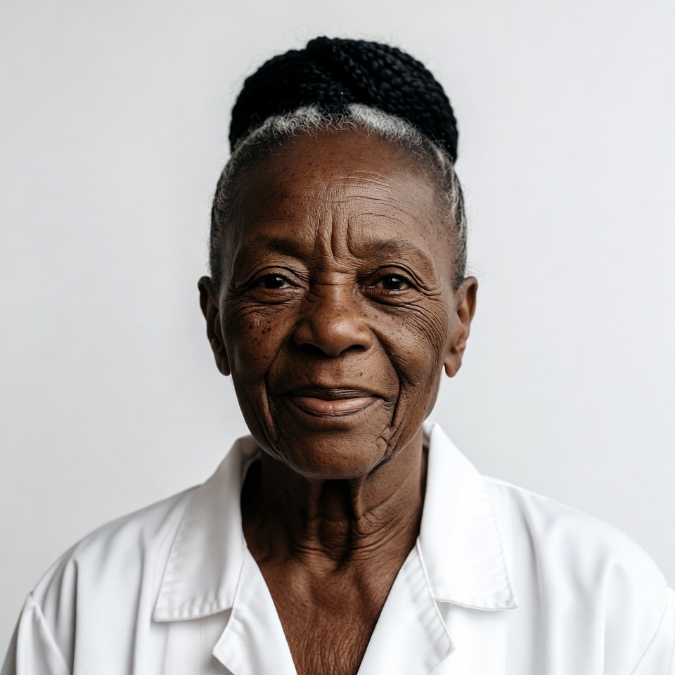 Elderly African-American woman in white coat Elderly African-American woman in white coat