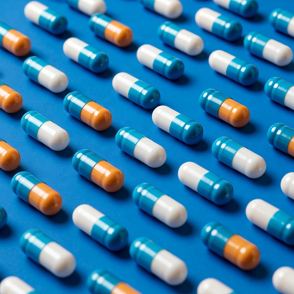 Blue and Orange Capsules on Blue Background Blue and Orange Capsules on Blue Background