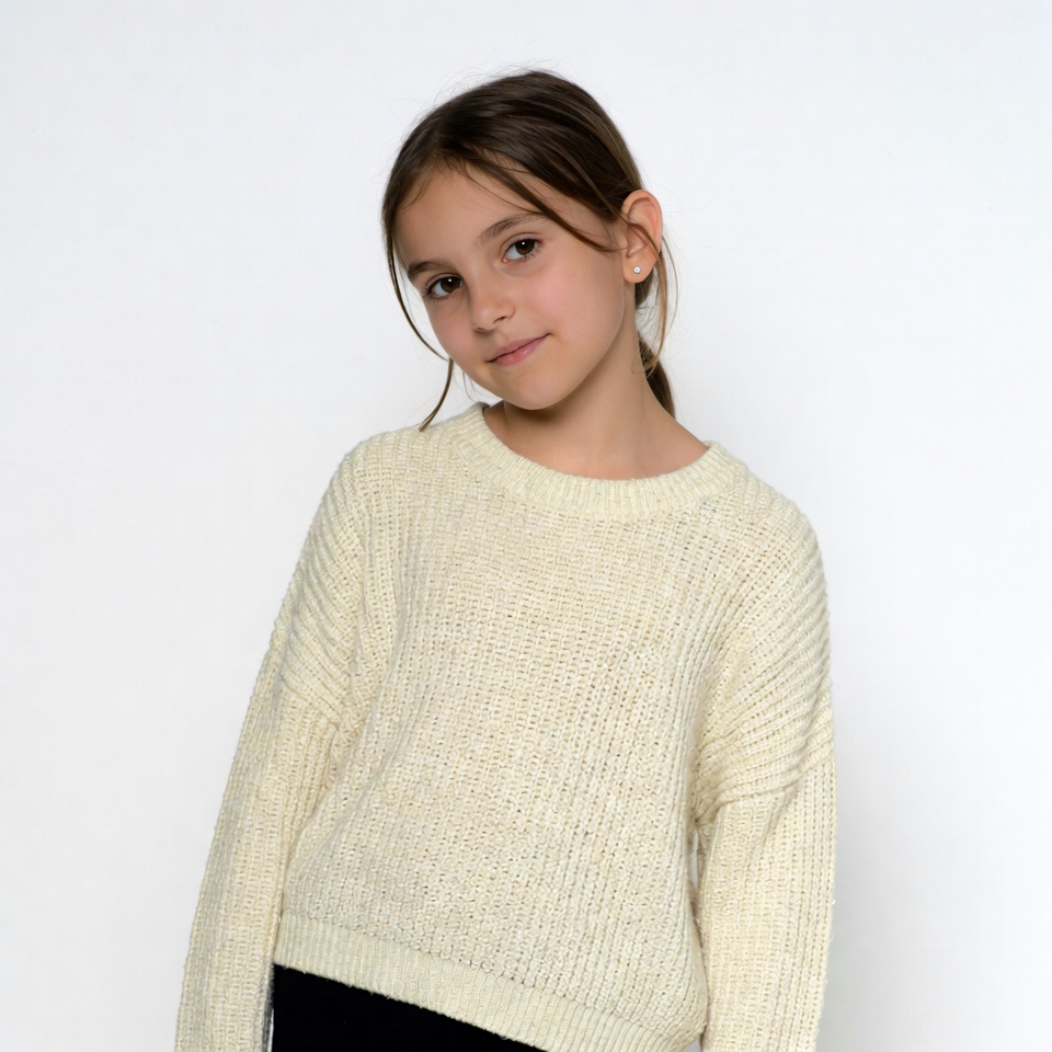 Girl smiling in cream knit sweater Girl smiling in cream knit sweater