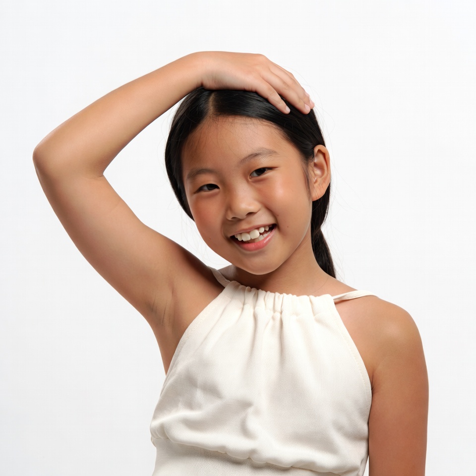 Asian girl smiling hand on head Asian girl smiling hand on head