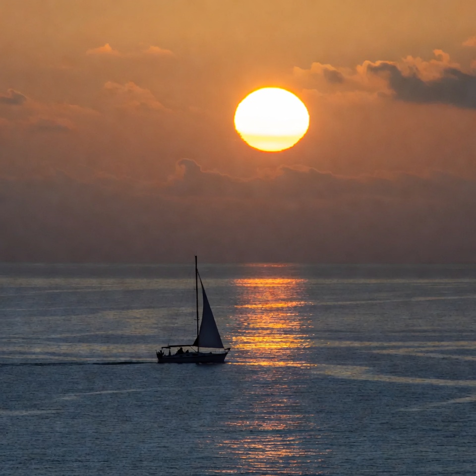 Sailboat at Sunset on Calm Sea Sailboat at Sunset on Calm Sea