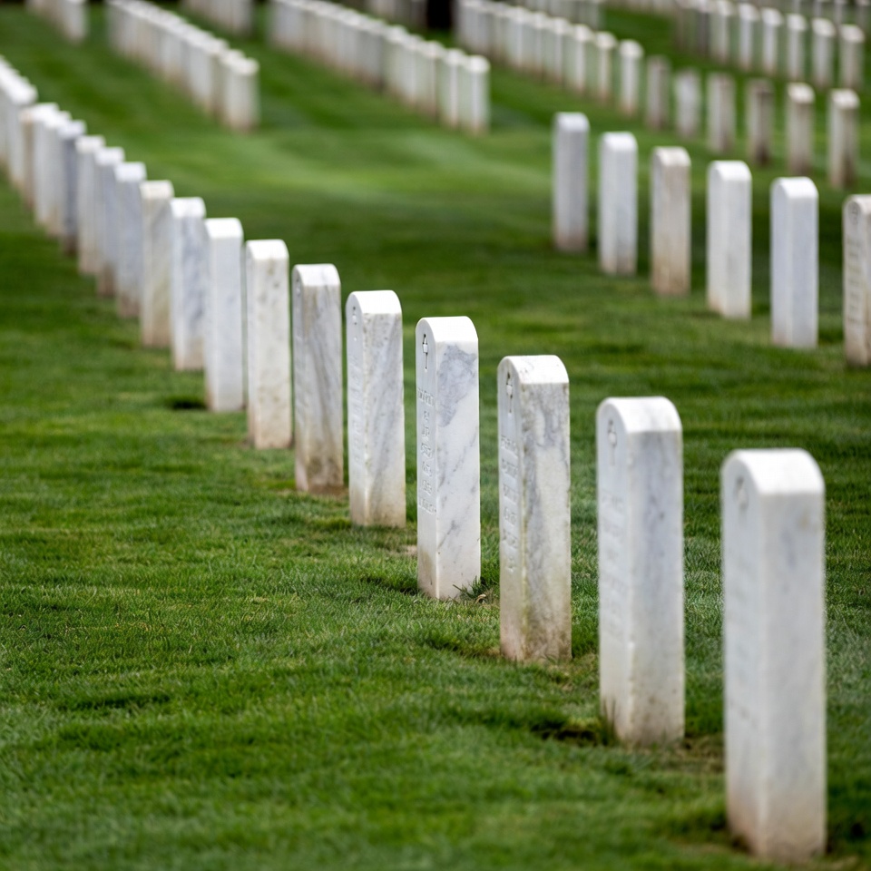 Rows of White Headstones in Green Cemetery Rows of White Headstones in Green Cemetery