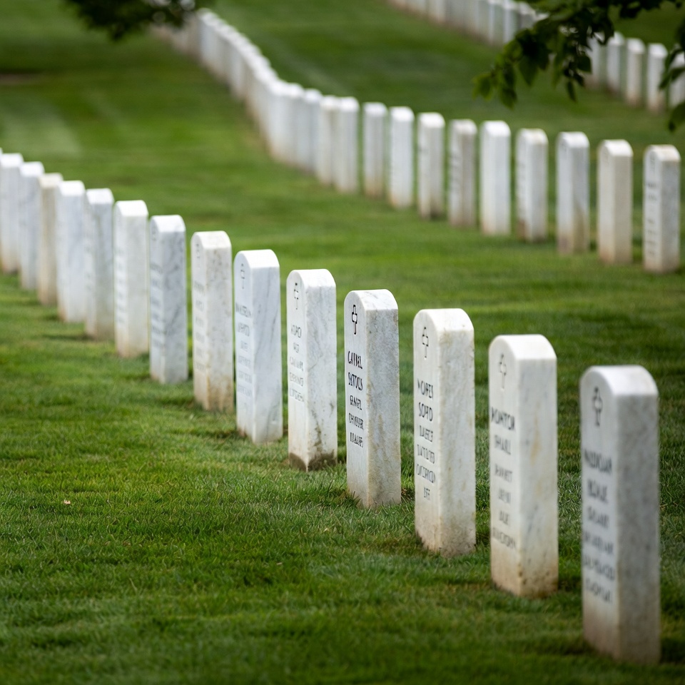 Rows of White Headstones in Green Cemetery Rows of White Headstones in Green Cemetery