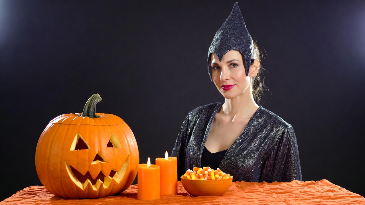 Woman in witch costume with jack-o-lantern Woman in witch costume with jack-o-lantern