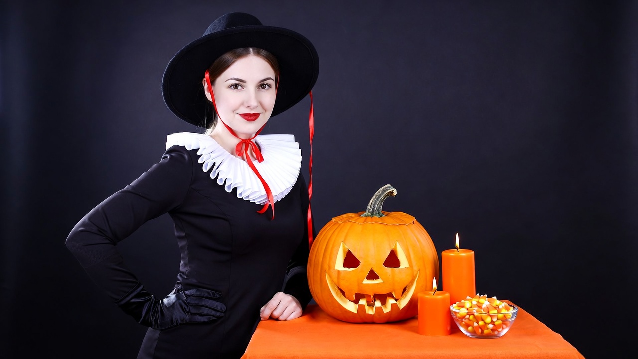 Woman in witch costume with jack-o-lantern Woman in witch costume with jack-o-lantern