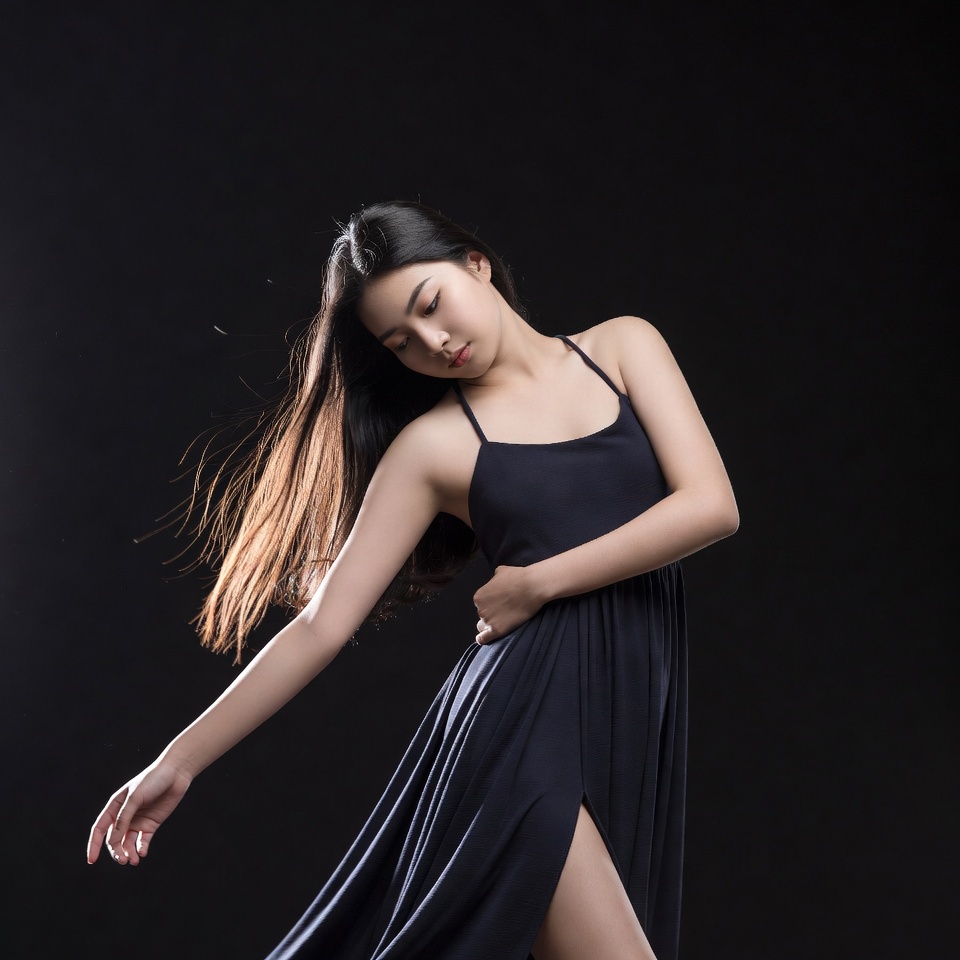 Asian woman dancing in black dress Asian woman dancing in black dress