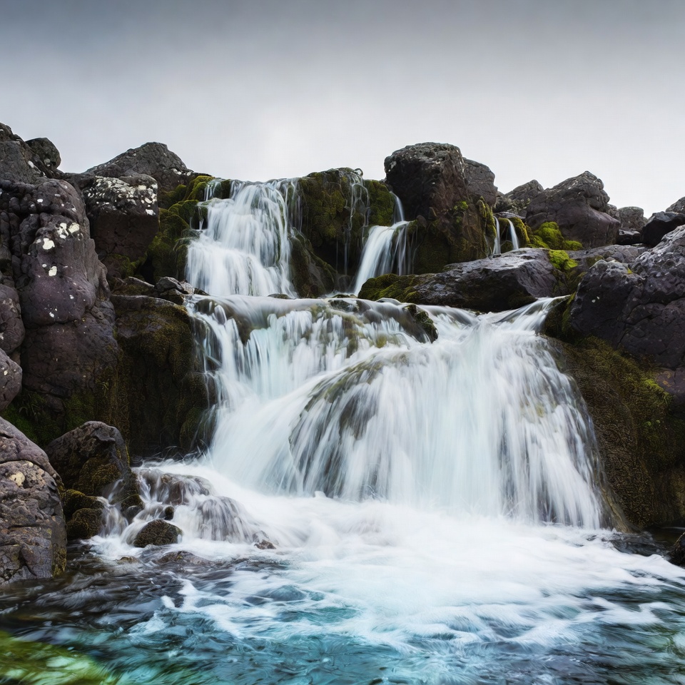 Waterfall cascading over mossy rocks Waterfall cascading over mossy rocks