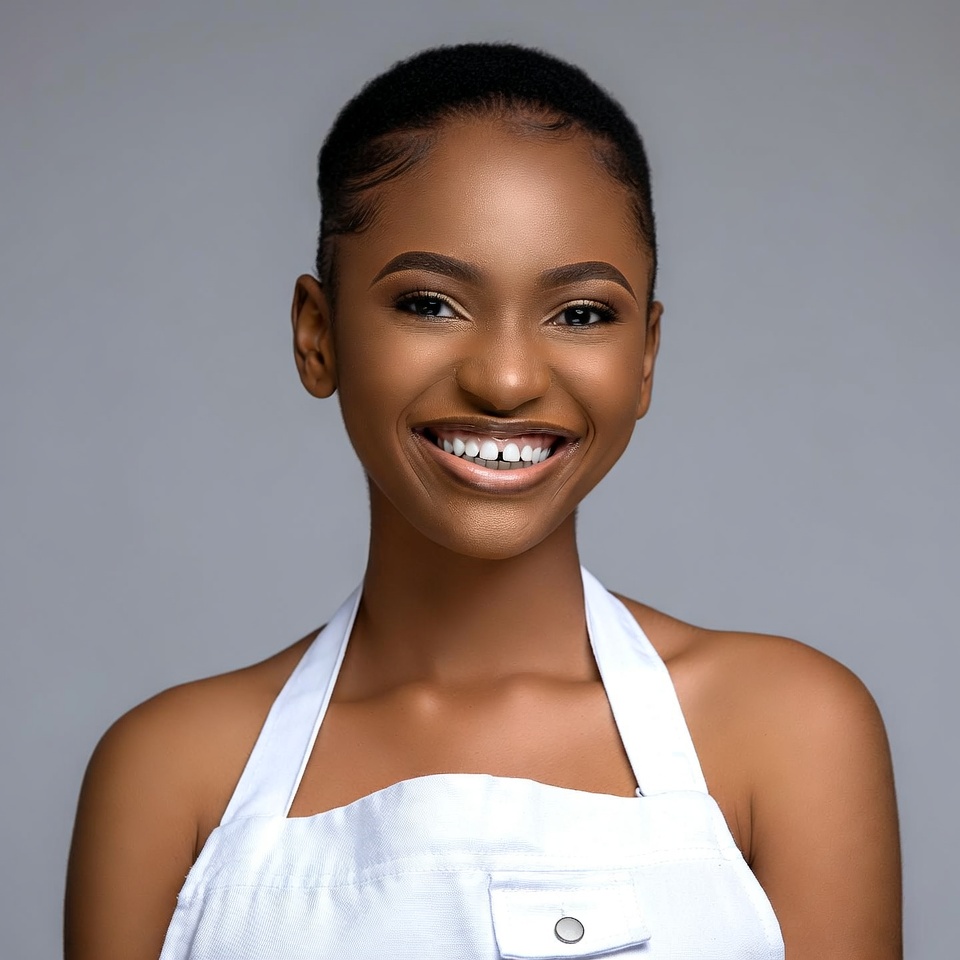 Smiling African-American woman in white apron Smiling African-American woman in white apron