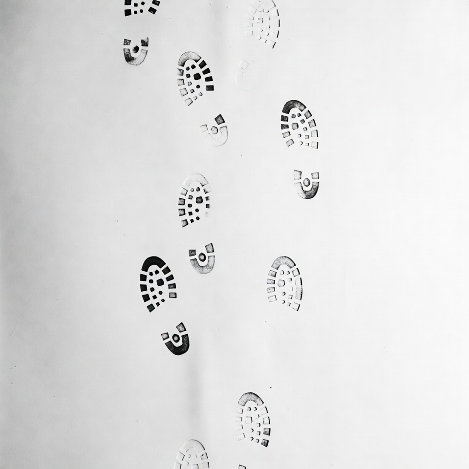 Boot footprints trail on white Boot footprints trail on white