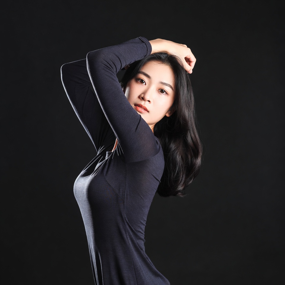 Asian woman posing with arm raised Asian woman posing with arm raised