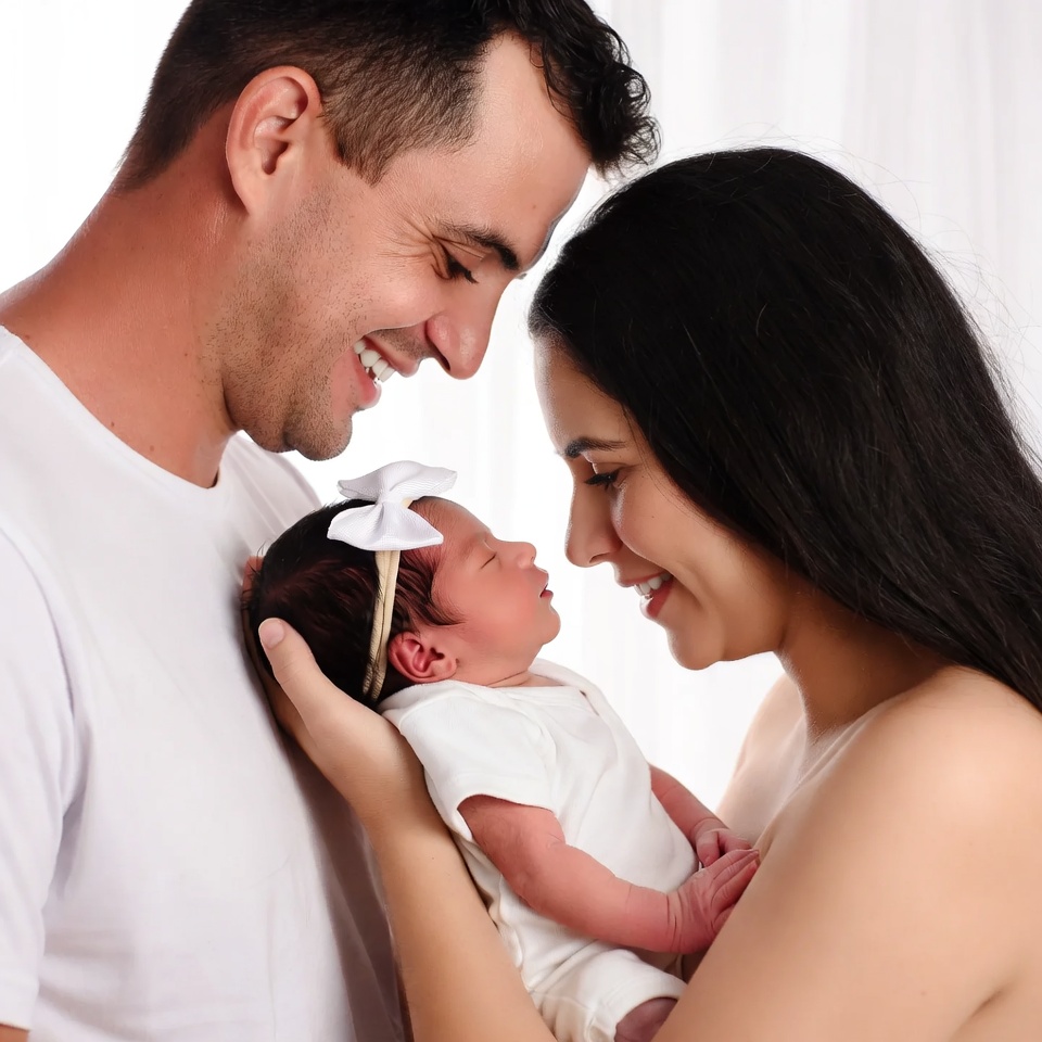 Parents smiling at newborn baby Parents smiling at newborn baby