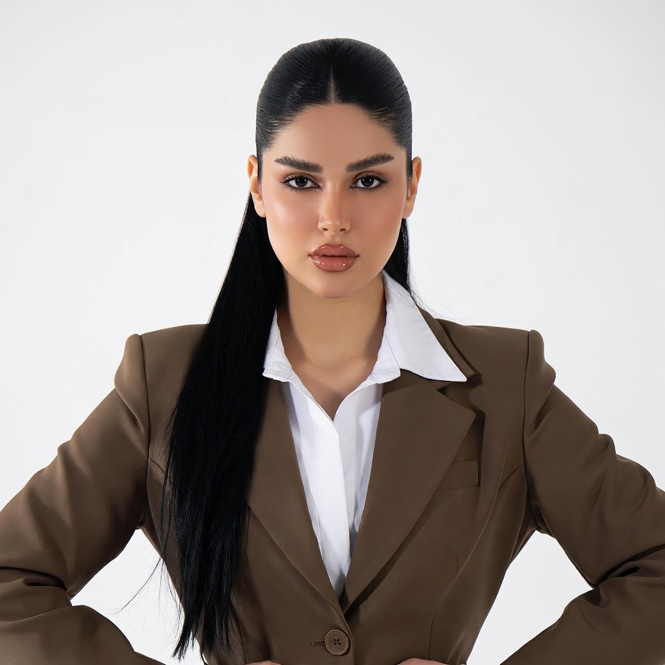 Middle Eastern woman in brown blazer Middle Eastern woman in brown blazer