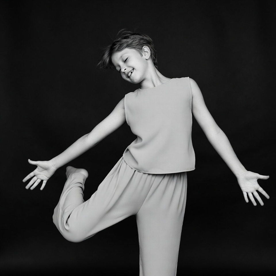 Boy dancing with arms outstretched Boy dancing with arms outstretched