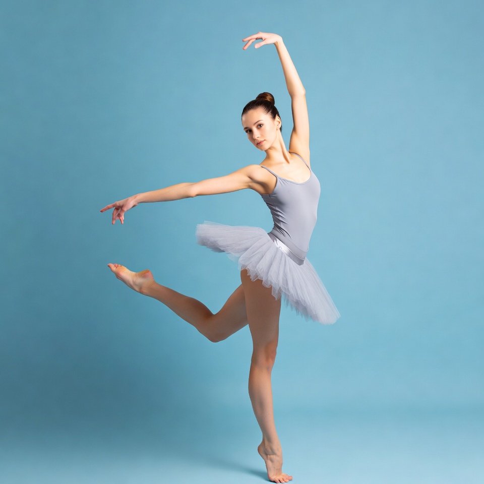 Ballerina in gray tutu on blue background Ballerina in gray tutu on blue background
