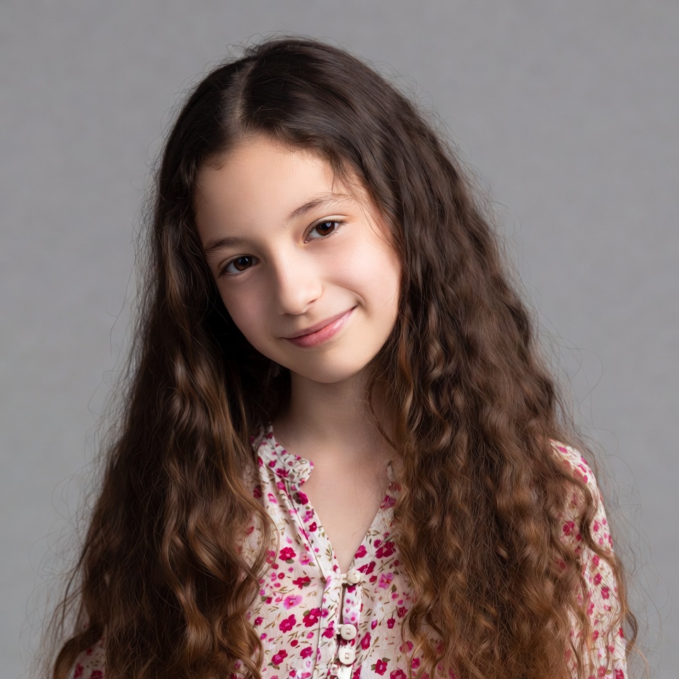 Girl with curly brown hair smiling Girl with curly brown hair smiling