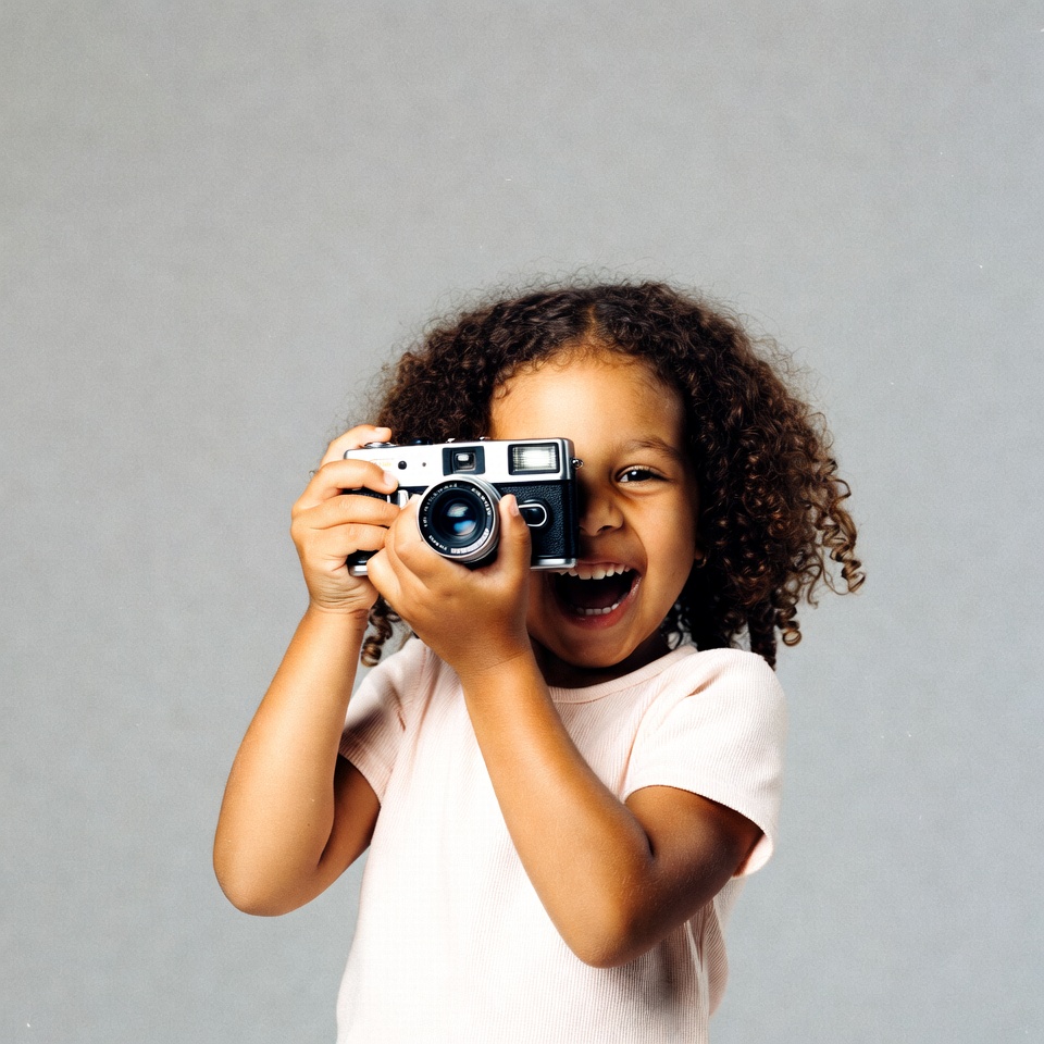 Happy Black girl holding camera Happy Black girl holding camera
