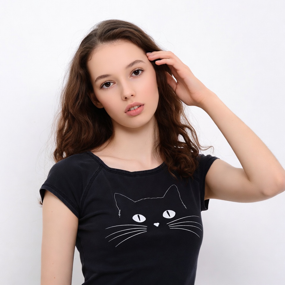 Young woman in cat t-shirt touching hair Young woman in cat t-shirt touching hair