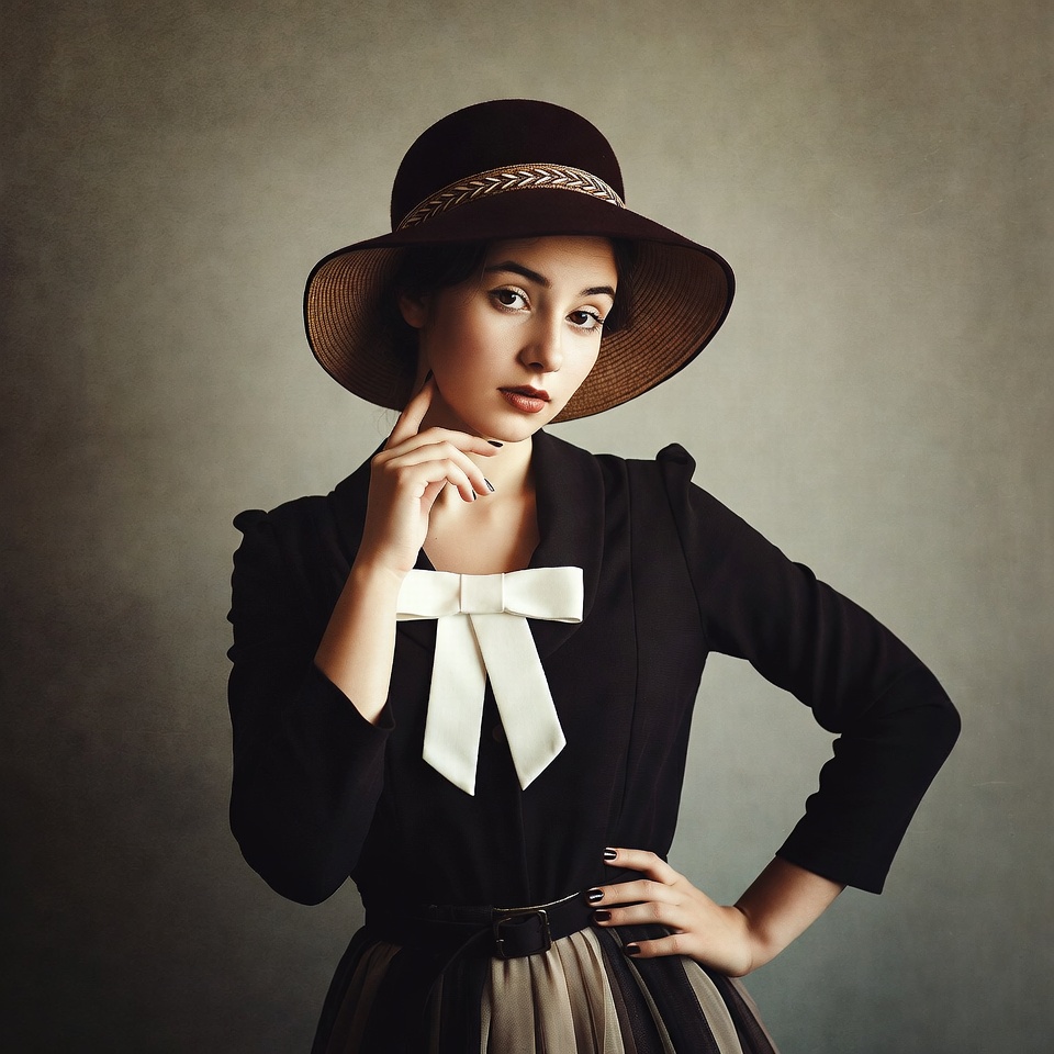 Woman in wide-brim hat posing thoughtfully Woman in wide-brim hat posing thoughtfully