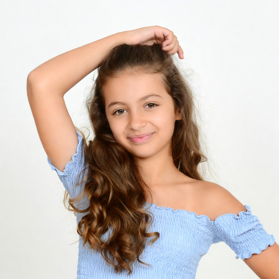 Girl posing with hand in hair Girl posing with hand in hair