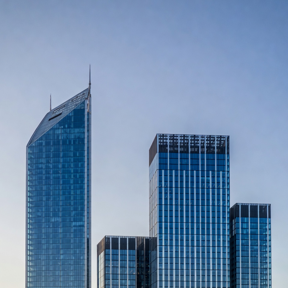 Modern Glass Skyscrapers Against Blue Sky Modern Glass Skyscrapers Against Blue Sky