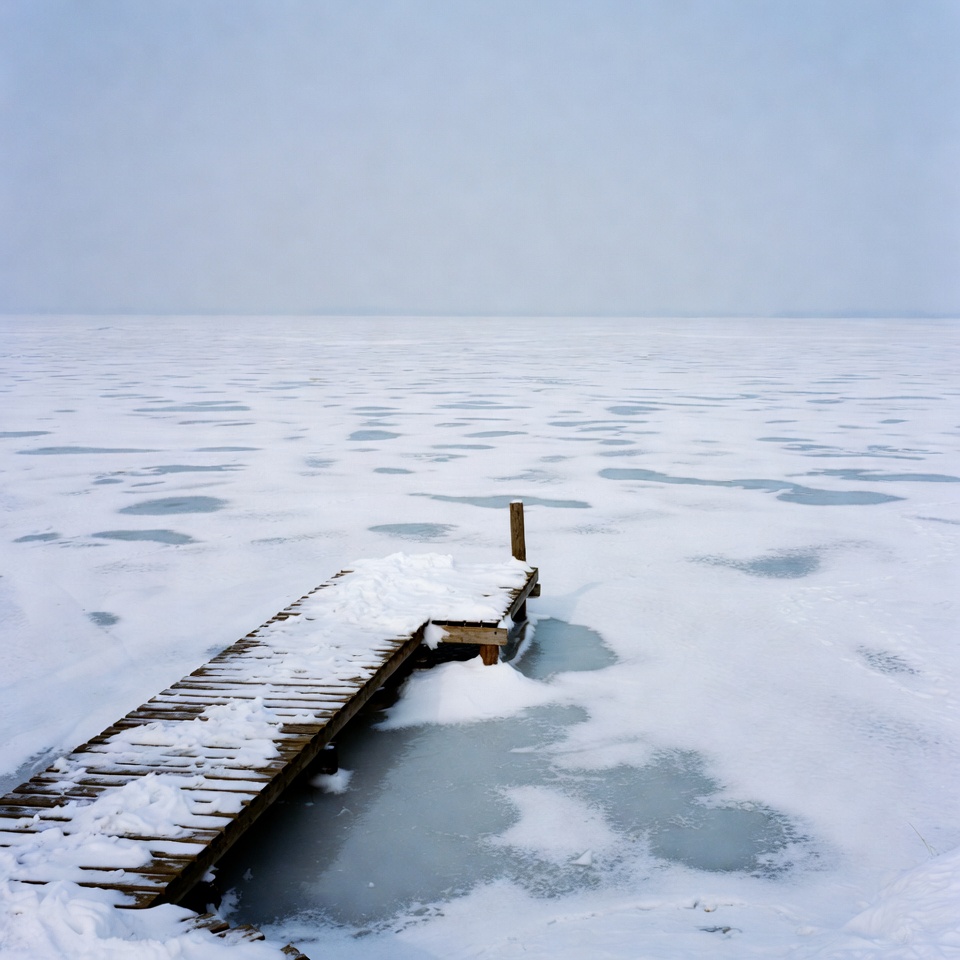 Snowy Wooden Pier on Frozen Lake Snowy Wooden Pier on Frozen Lake