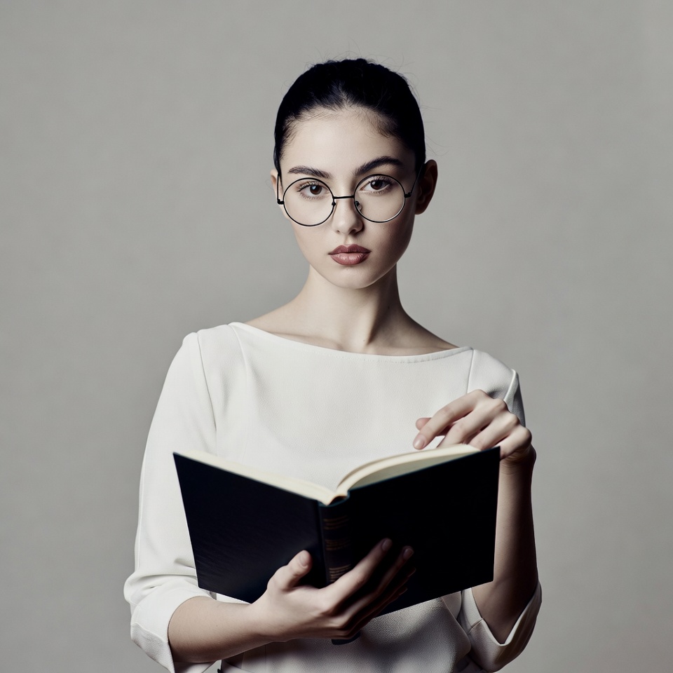 Woman reading book in glasses Woman reading book in glasses