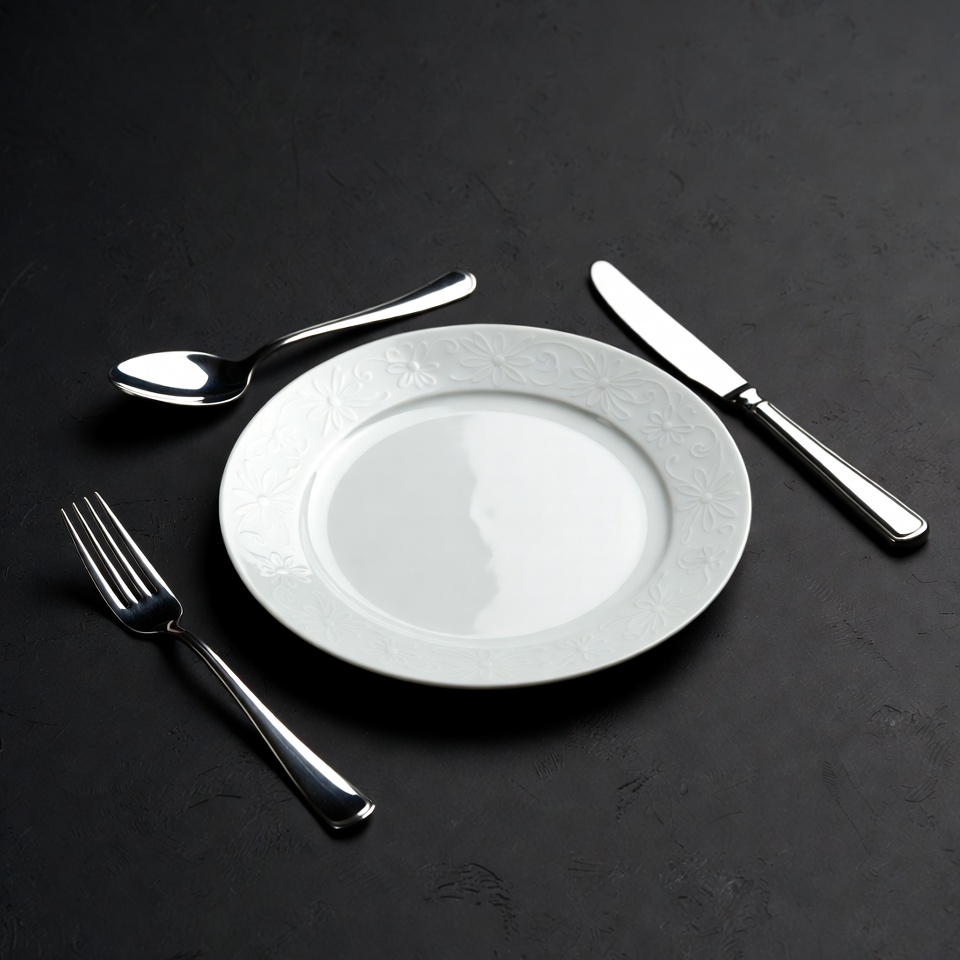 White Plate with Silverware on Black White Plate with Silverware on Black