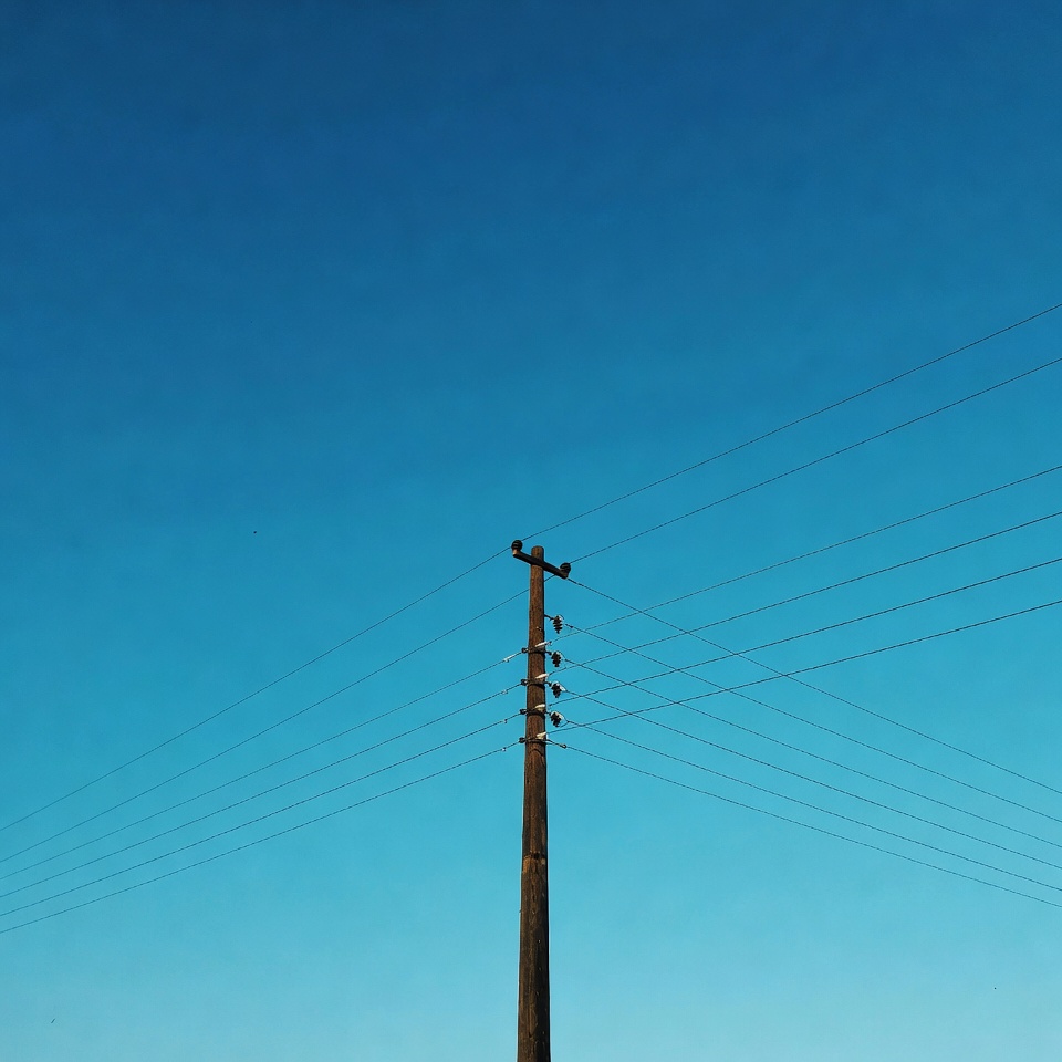 Utility Pole Against Blue Sky Utility Pole Against Blue Sky