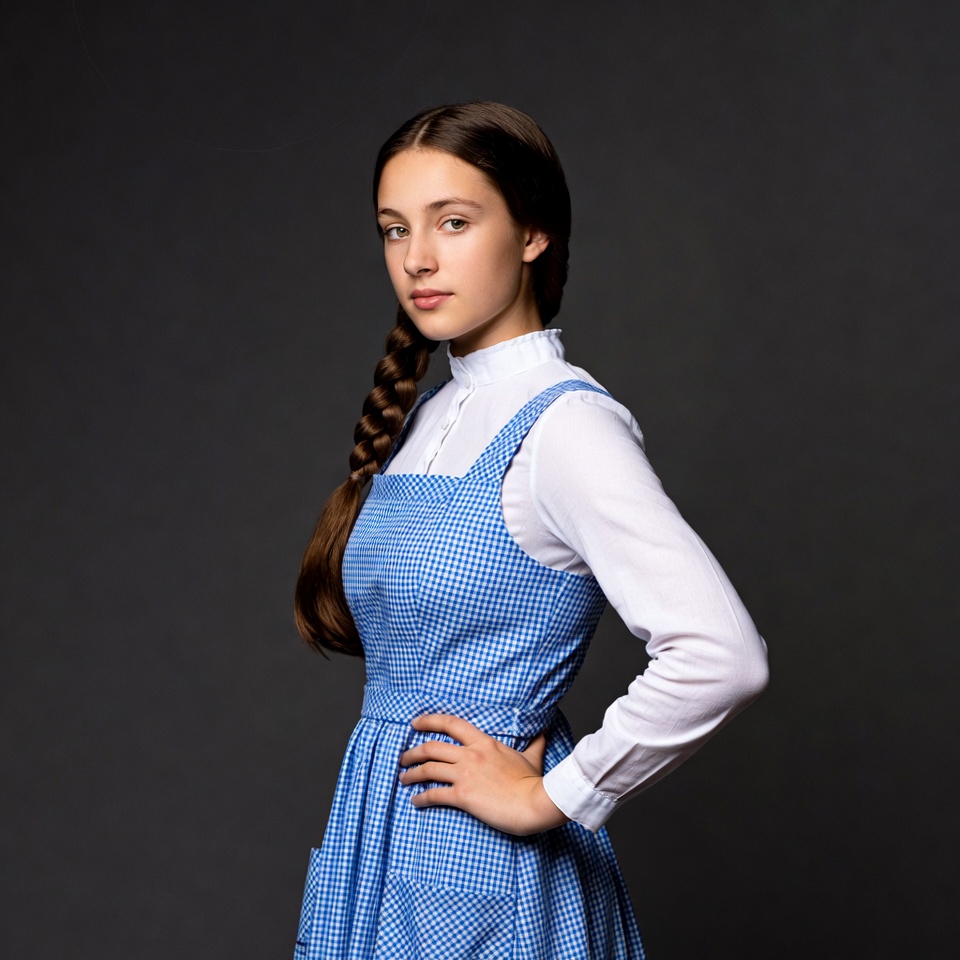 Girl in blue gingham pinafore dress Girl in blue gingham pinafore dress