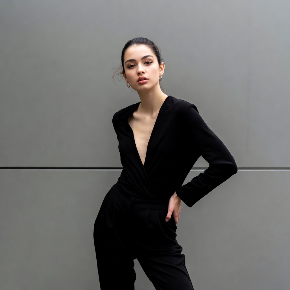 Woman in black jumpsuit posing Woman in black jumpsuit posing