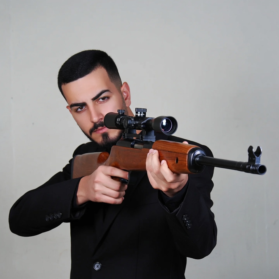 Man aiming sniper rifle in suit Man aiming sniper rifle in suit