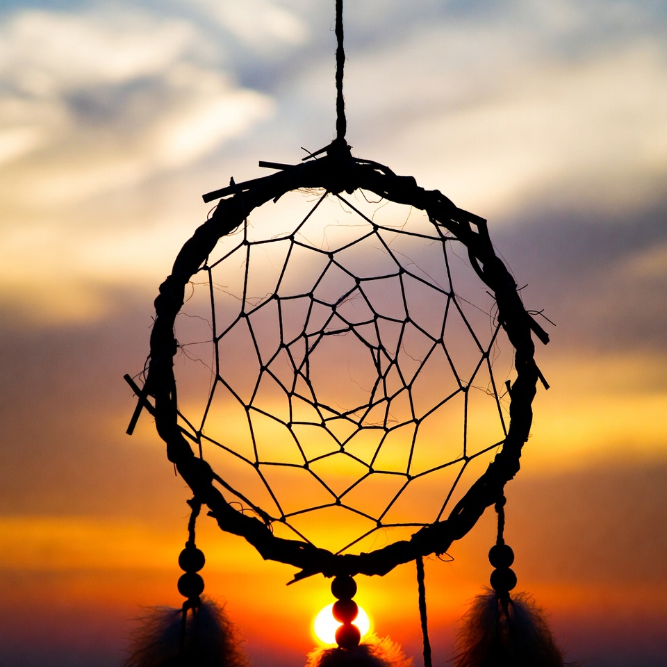 Dreamcatcher against sunset sky Dreamcatcher against sunset sky
