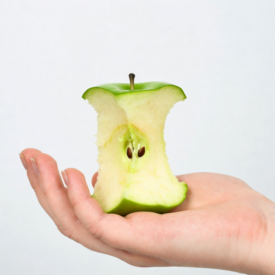 Woman holding bitten green apple Woman holding bitten green apple