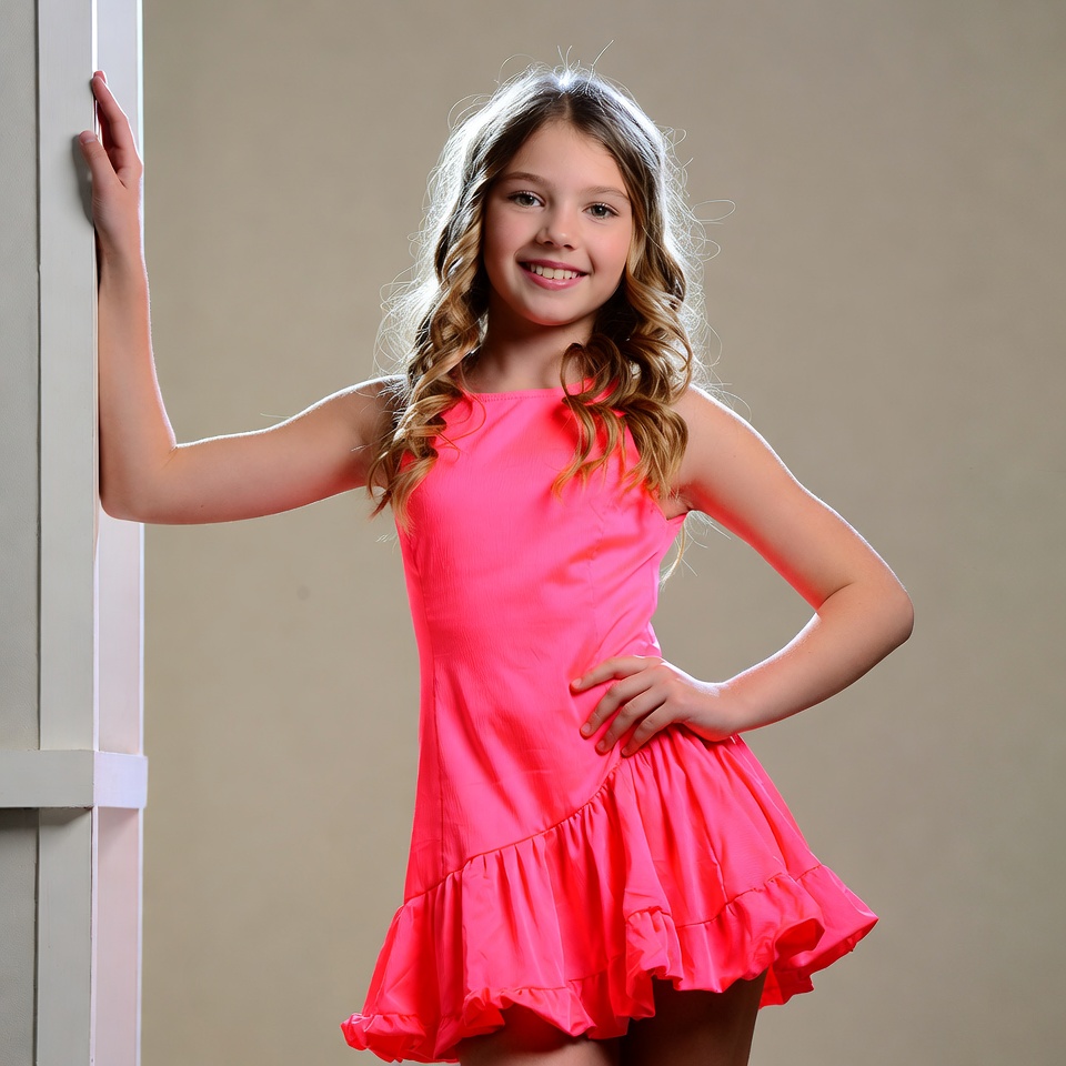 Girl in pink dress leaning on doorframe Girl in pink dress leaning on doorframe