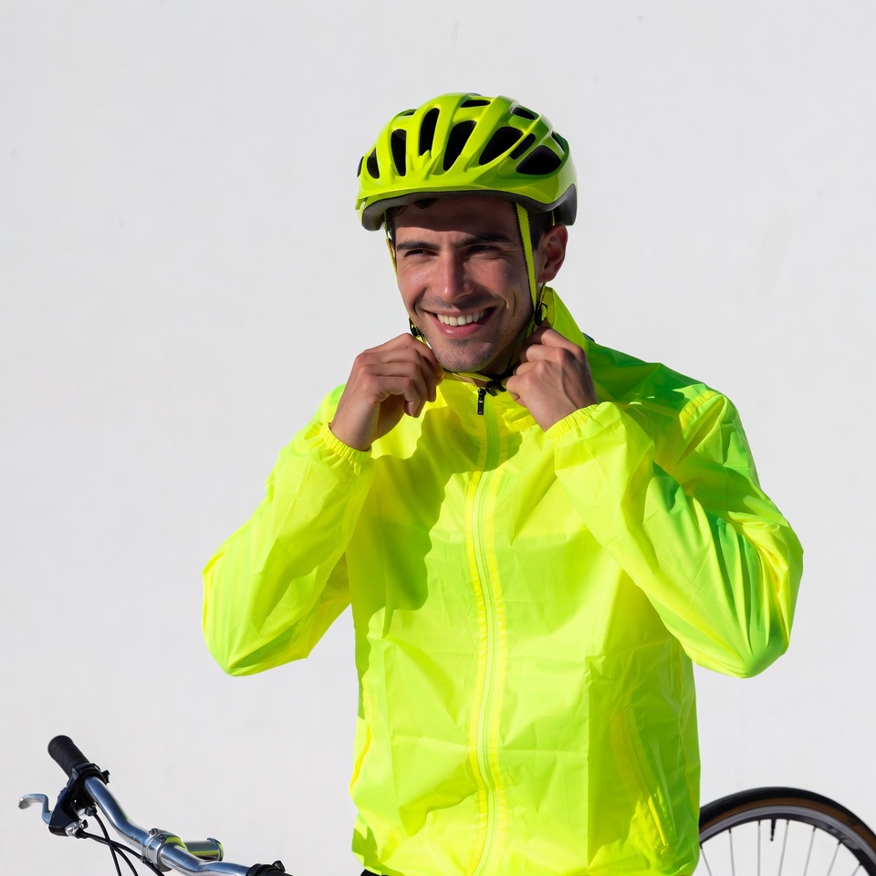 Man adjusting yellow helmet with bike Man adjusting yellow helmet with bike