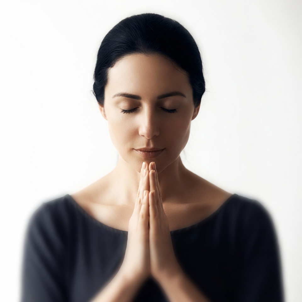 Woman praying with hands clasped Woman praying with hands clasped
