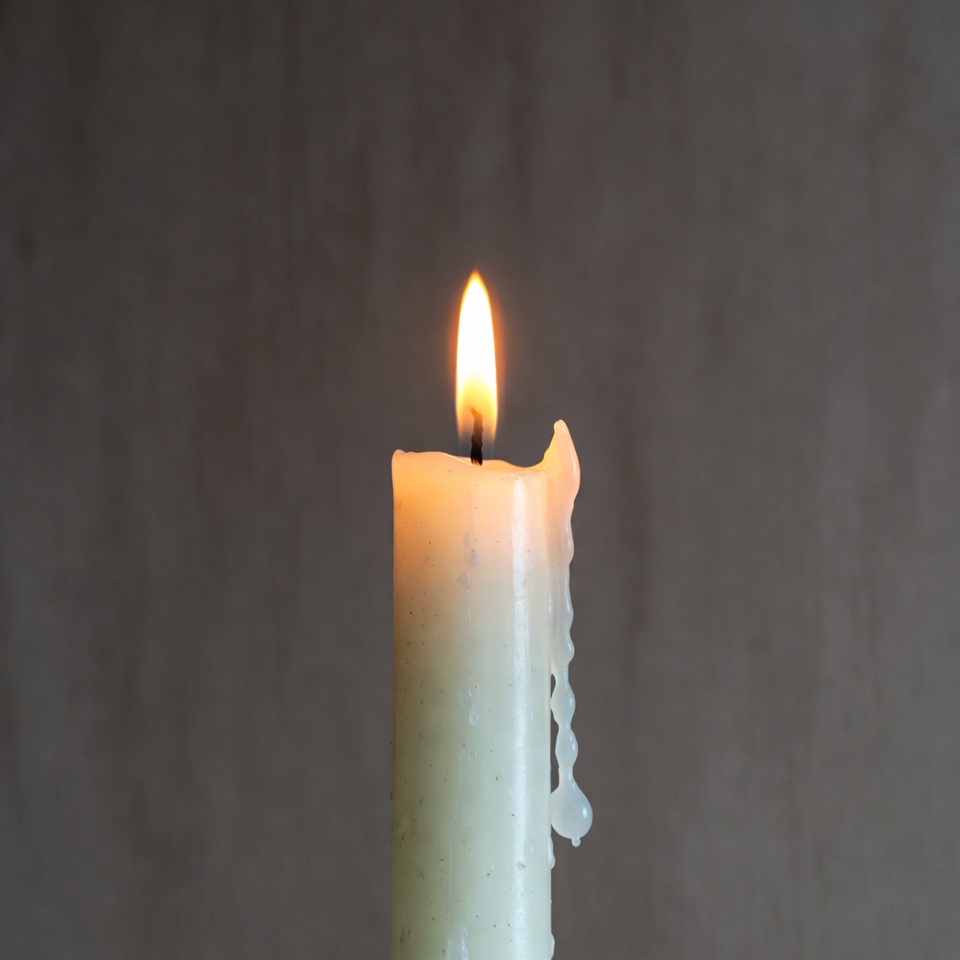 Burning White Candle with Dripping Wax Burning White Candle with Dripping Wax