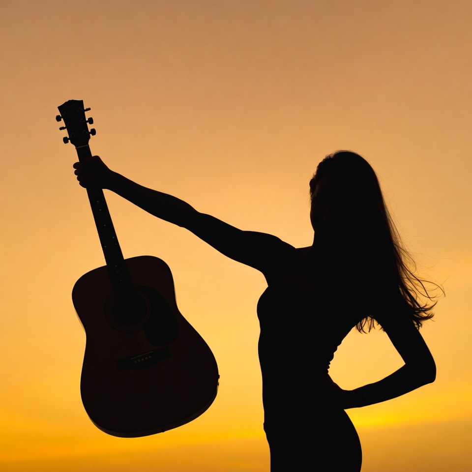 Woman holding guitar silhouette sunset Woman holding guitar silhouette sunset