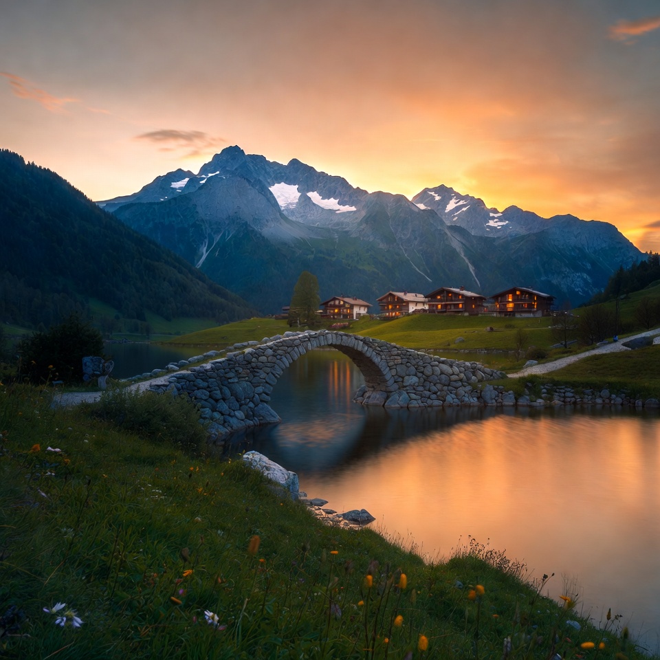 Stone Bridge over Lake with Swiss Chalet Mountains Stone Bridge over Lake with Swiss Chalet Mountains