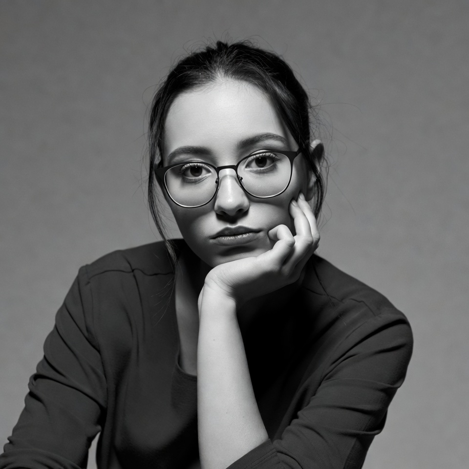 Asian woman in glasses thoughtful pose Asian woman in glasses thoughtful pose