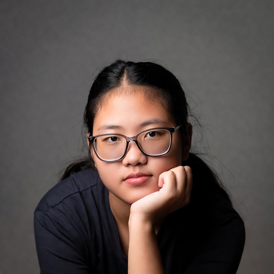 Asian girl with glasses resting chin Asian girl with glasses resting chin