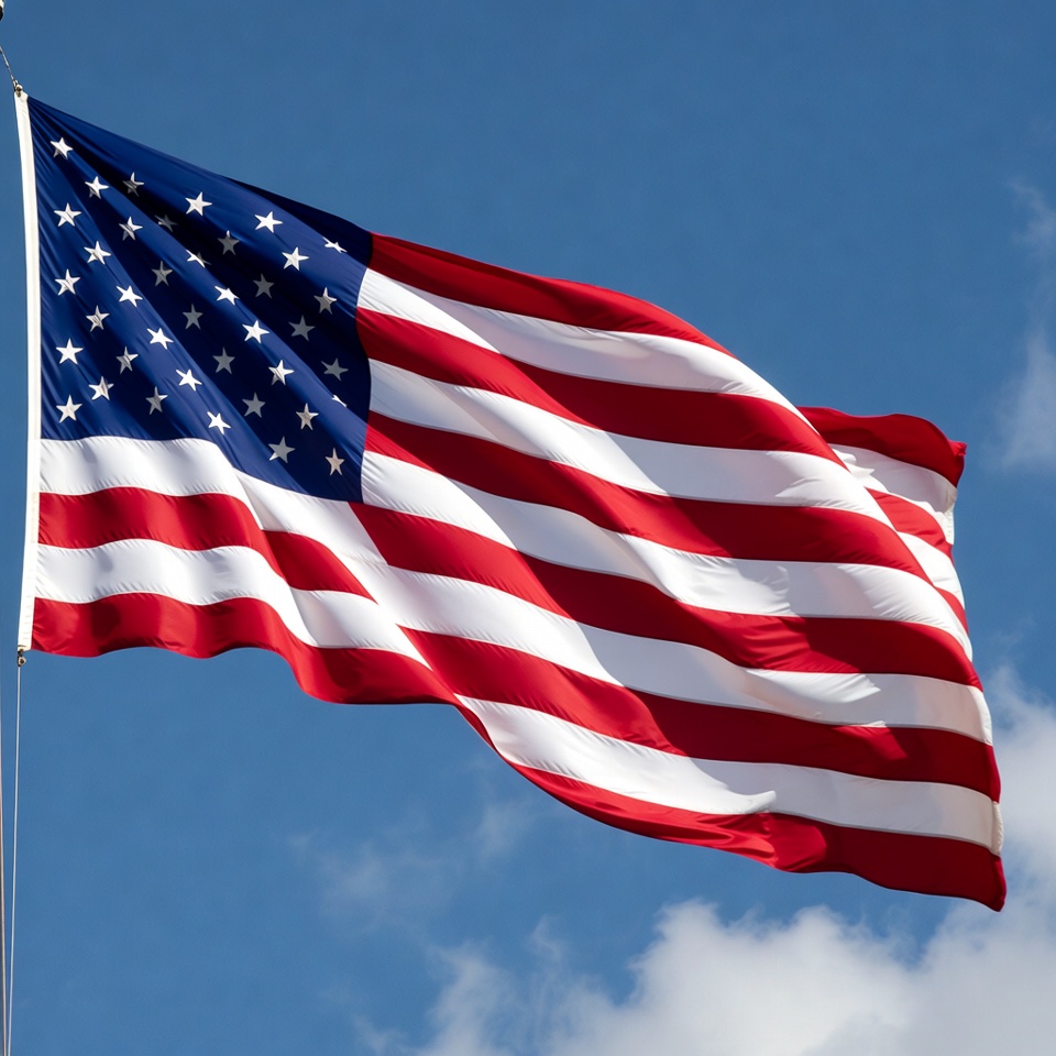 American flag waving in blue sky American flag waving in blue sky