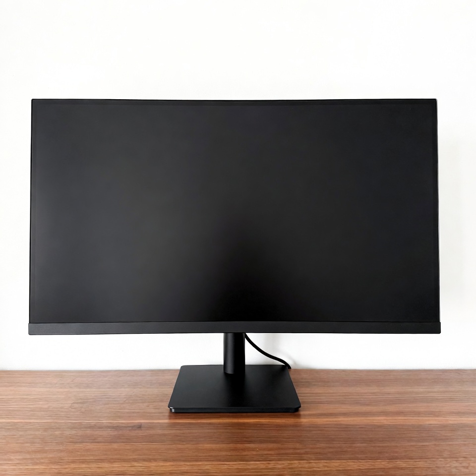 Black curved monitor on wooden desk Black curved monitor on wooden desk