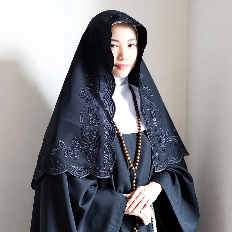 Asian nun in black habit with rosary Asian nun in black habit with rosary