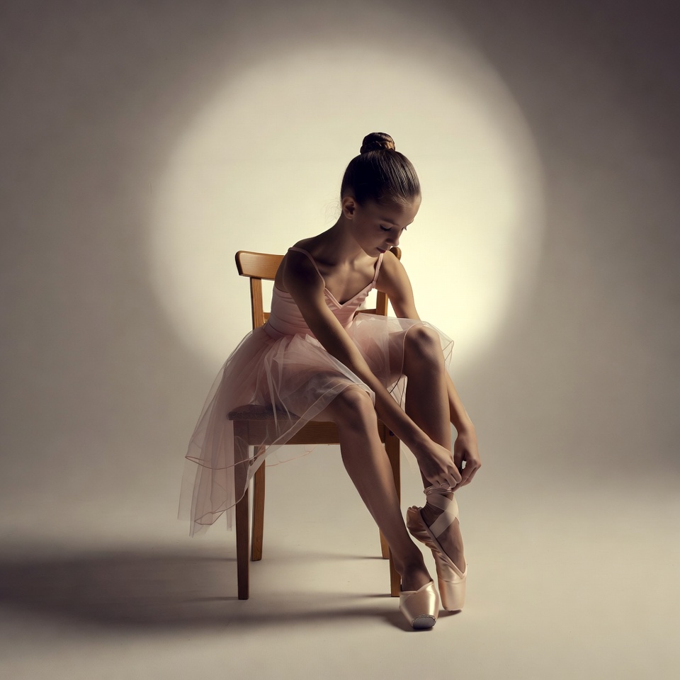 Young girl tying ballet slippers Young girl tying ballet slippers