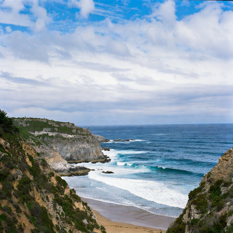 Cliff-framed beach with ocean waves Cliff-framed beach with ocean waves