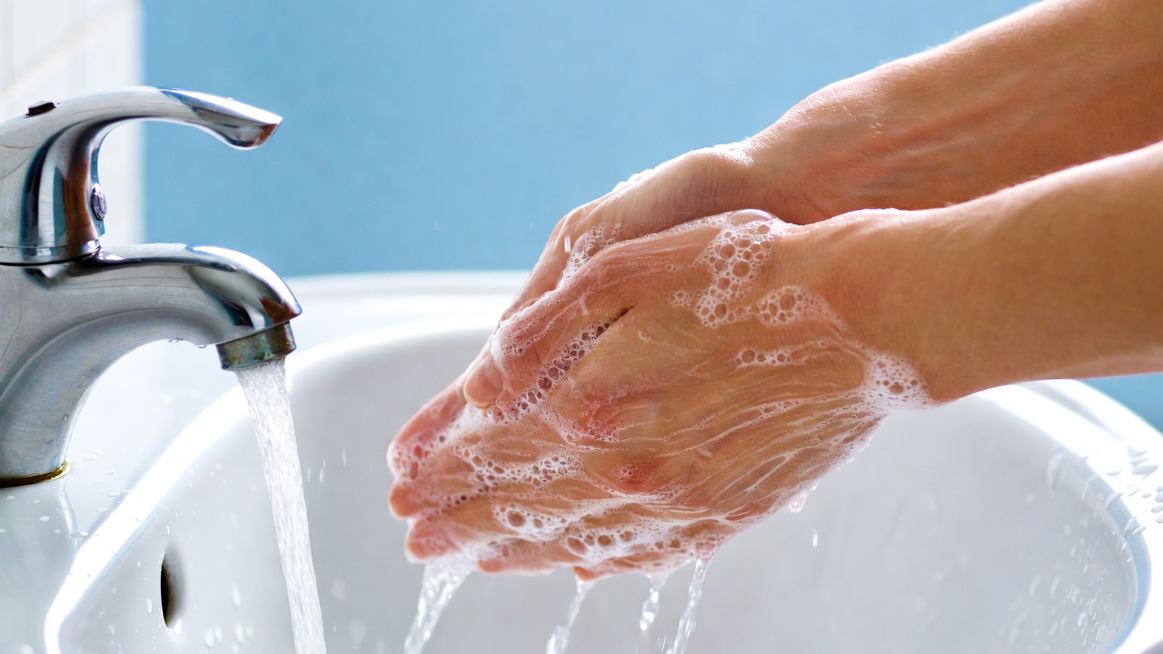 Hands washing with soap under faucet Hands washing with soap under faucet