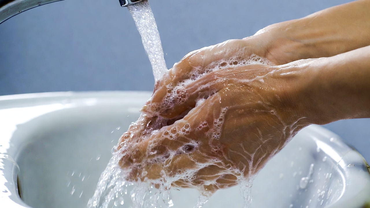 Hands washing with soap under faucet Hands washing with soap under faucet