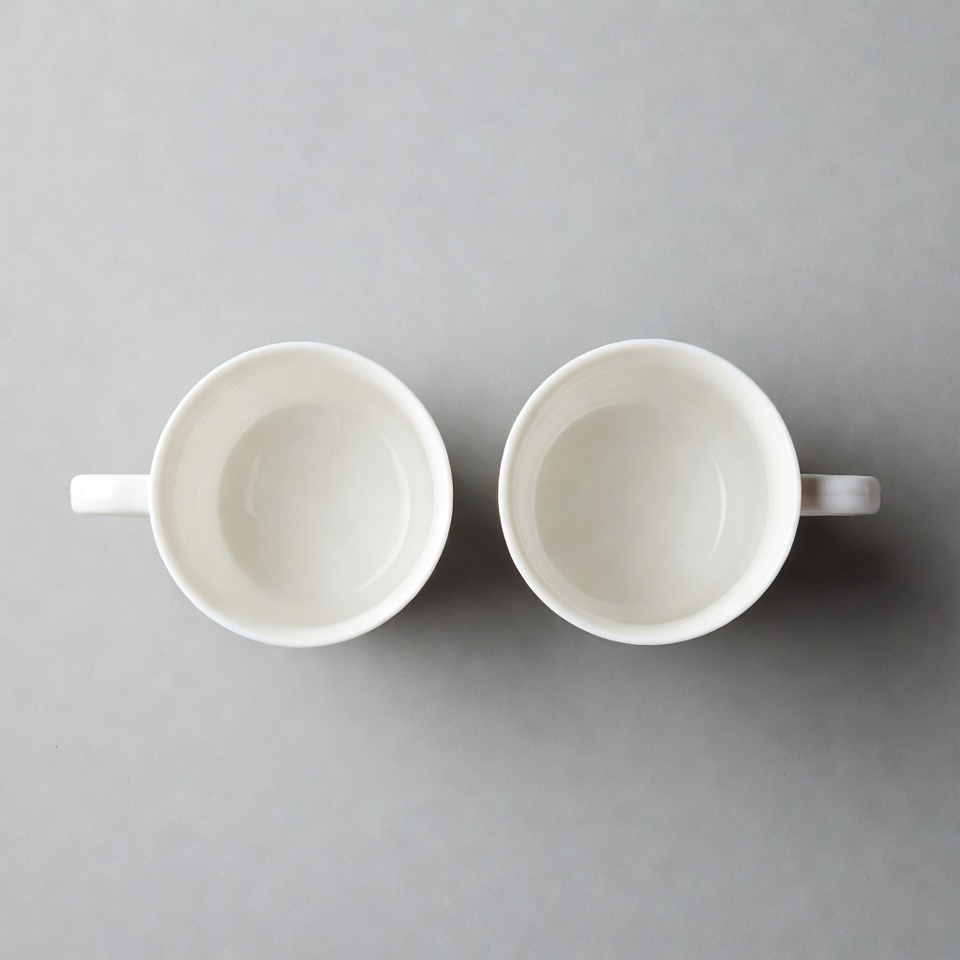 Two white empty mugs Two white empty mugs