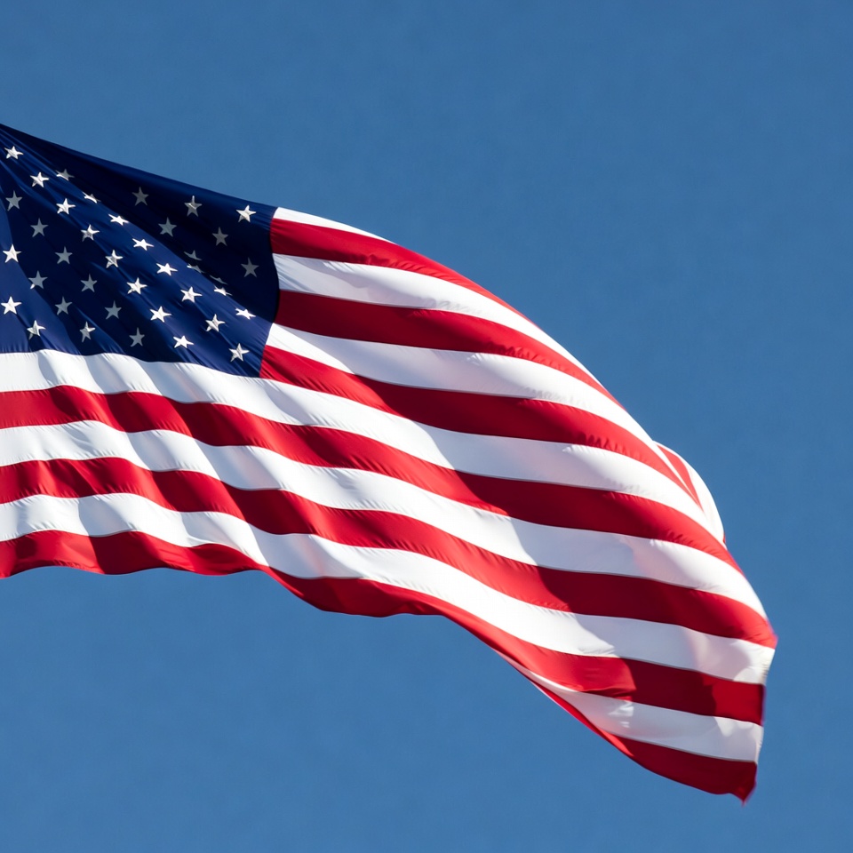 American flag waving in blue sky American flag waving in blue sky